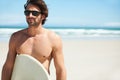 Summer, surfing and travel with a man on the beach for sky space, freedom or adventure on vacation. Sand, sunglasses and