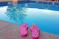 polka dot flip-flops by swimming pool Royalty Free Stock Photo