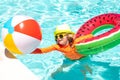 Summer swimming and relax, swim on ring in pool, poolside. Cute funny child boy relaxing with toy swimming ring in a Royalty Free Stock Photo