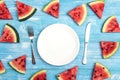 Summer table setting with cutlery and sliced watermelon on blue wooden table. Royalty Free Stock Photo