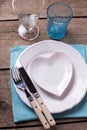 Summer table setting. Decorative plate in form of heart, knife