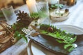 Summer table setting in natural organic style with handmade details in green and brown tones