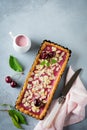 Summer tart with cherry custard on a gray deton background. Selective focus.Top view. Copy space Royalty Free Stock Photo