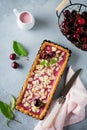 Summer tart with cherry custard on a gray deton background. Selective focus.Top view. Copy space Royalty Free Stock Photo