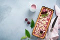 Summer tart with cherry custard on a gray deton background. Selective focus.Top view. Copy space Royalty Free Stock Photo