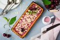 Summer tart with cherry custard on a gray deton background. Selective focus.Top view. Copy space Royalty Free Stock Photo