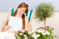 Summer terrace red hair woman relax in deckchair