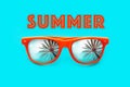 Summer text and Orange sunglasses with palm tree reflections isolated in intense cyan background. Royalty Free Stock Photo