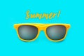 Summer! text and yellow sunglasses in intense cyan blue background. Minimal image concept for ready for summer