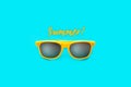 Summer! text and yellow sunglasses in intense cyan blue large negative space background. Minimal image concept for ready for summe Royalty Free Stock Photo
