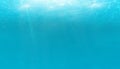 Summer. Texture of water surface. Underwater background with wave lights, bubbles of air, rays of sunshine. Waves effects. Blue un