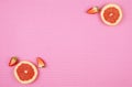 Summer theme background with ruby grapefruit on pink backdrop, with copy space. Royalty Free Stock Photo