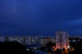 Summer thunderstorm with lightnings over the city night panorama from the height of the 12th floor. Royalty Free Stock Photo