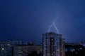 Summer thunderstorm with lightnings over the city night panorama from the height of the 12th floor. Royalty Free Stock Photo