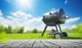 summer time in backyard garden with grill BBQ, wooden table, blurred backgroundd Royalty Free Stock Photo