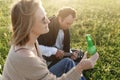 Summer time. Beautiful young couple enjoying time in field around grass. Lifestyle, love, dating, vacation concept Royalty Free Stock Photo