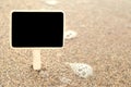 Summer time: Blank blackboard on sandy beach Royalty Free Stock Photo