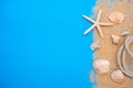 Summer time concept with sea shells and starfish on a blue wooden background and sand Royalty Free Stock Photo