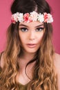 Summer time exotic floral portrait of young beautiful woman with long hair and hair flowers accessorize