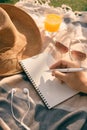 Summer time -  hands with pen writing on notebook in the park Royalty Free Stock Photo