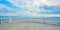 Summer time. Panoramic ocean view. Seascape. Empty promenade. Blue cloudy sky. Crystal calming sea water on horizon Royalty Free Stock Photo