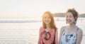 Summer time, portrait of two young women walking on the beach and smiling. Royalty Free Stock Photo