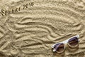 Summer time. Sandy beach and sunglasses. Inscription Summer 2018