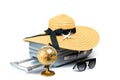 Summer time. Travel accessories with suitcase, straw hat, toy airplane and globe in minimal trip vacation concept isolated on Royalty Free Stock Photo