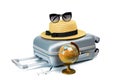 Summer time. Travel accessories with suitcase, straw hat, toy airplane and globe in minimal trip vacation concept isolated on Royalty Free Stock Photo