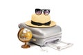 Summer time. Travel accessories with suitcase, straw hat, toy airplane and globe in minimal trip vacation concept isolated on Royalty Free Stock Photo