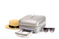 Summer time. Travel accessories with suitcase, straw hat, toy airplane in minimal trip vacation concept isolated on white Royalty Free Stock Photo