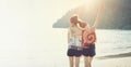 Summer time, Two girls hugging their necks and turning their backs on the beach. Royalty Free Stock Photo