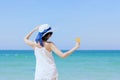 Summer time woman vacation on the beach. Cheerful woman wear summer dress and straw hats sitting on the beach look at sea. Time to Royalty Free Stock Photo