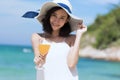 Summer time woman vacation on the beach. Cheerful woman wear summer dress and straw hats sitting on the beach look at sea. Time to Royalty Free Stock Photo