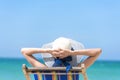 Summer time woman vacation on the beach. Cheerful woman wear summer dress and straw hats sitting on the beach look at sea. Time to Royalty Free Stock Photo