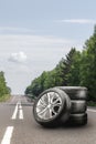 summer tires and alloy wheels set on an asphalt road. tire change season, auto trade, copy space, square photo. auto Royalty Free Stock Photo
