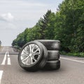 summer tires and alloy wheels set on an asphalt road. tire change season, auto trade, copy space, square photo Royalty Free Stock Photo