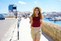 Summer tourism in Italy. Young woman strolling in Gallipoli seaside town of Apulia