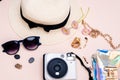 summer travel accessories. camera, hat, glasses and a flat Notepad top view lay flat on a light background