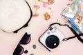 summer travel accessories. camera, hat, glasses and a flat Notepad top view lay flat on a light background