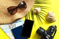 Summer travel accessories on yellow background. Flat lay beach hat, vintage camera, plane, map, passport, sunglasses, seashells Royalty Free Stock Photo