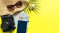 Summer travel accessories on yellow background. Flat lay beach hat, vintage camera, plane, map, passport, sunglasses, seashells Royalty Free Stock Photo