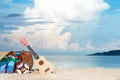 Summer Travel. Bikini and Flip-flops ,hat, and bag near beach chair on sandy beach against blue sea and sky Royalty Free Stock Photo