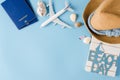 Summer travel concept. Decorative airplane, passports, hat and seashells.