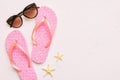 Summer travel concept. Flip flops, sunglasses and starfish on white. Top view on colored background