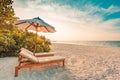 Summer travel destination background. Summer beach scene, sun beds sun umbrella and palm trees Royalty Free Stock Photo