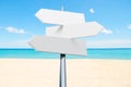 summer travel destinations options. Direction road sign with arrows on beach and sea