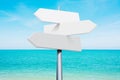 summer travel destinations options. Direction road sign with arrows on beach and sea Royalty Free Stock Photo