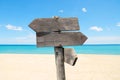 summer travel destinations options. Direction road sign with wooden arrows on beach and sea Royalty Free Stock Photo