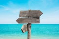 Summer travel destinations options.  Direction road sign with wooden arrows on beach and sea Royalty Free Stock Photo